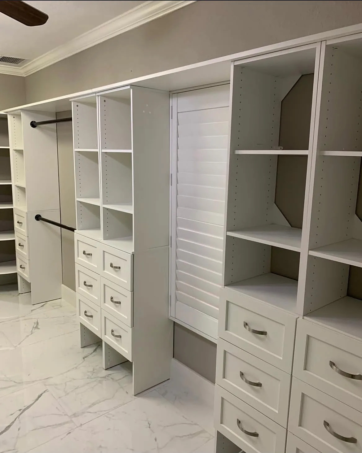 Close-up angle of white marble-look large-format porcelain tile flooring in closet