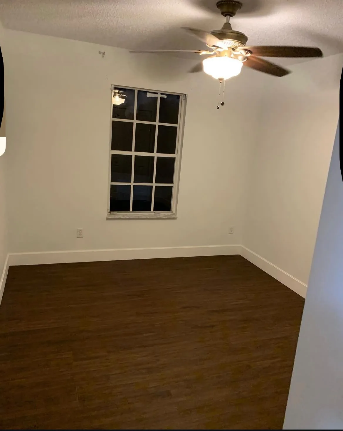 Finished bedroom with rich walnut-tone waterproof vinyl plank flooring